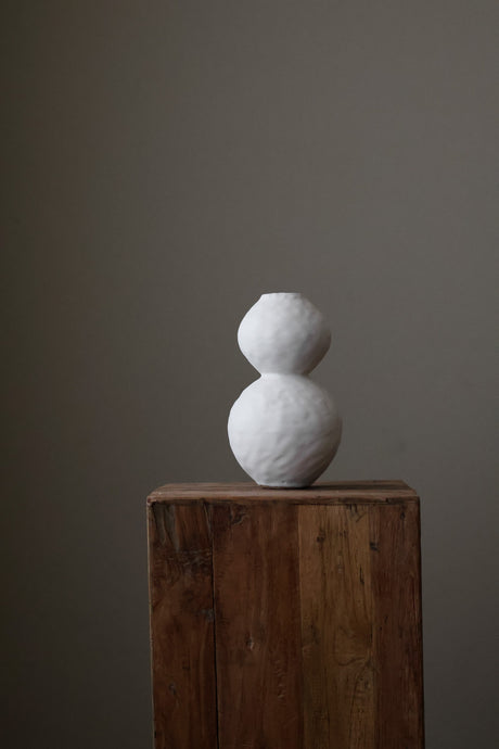 Hand-built white ceramic vase featuring two conjoined spherical shapes with a textured, matte finish.