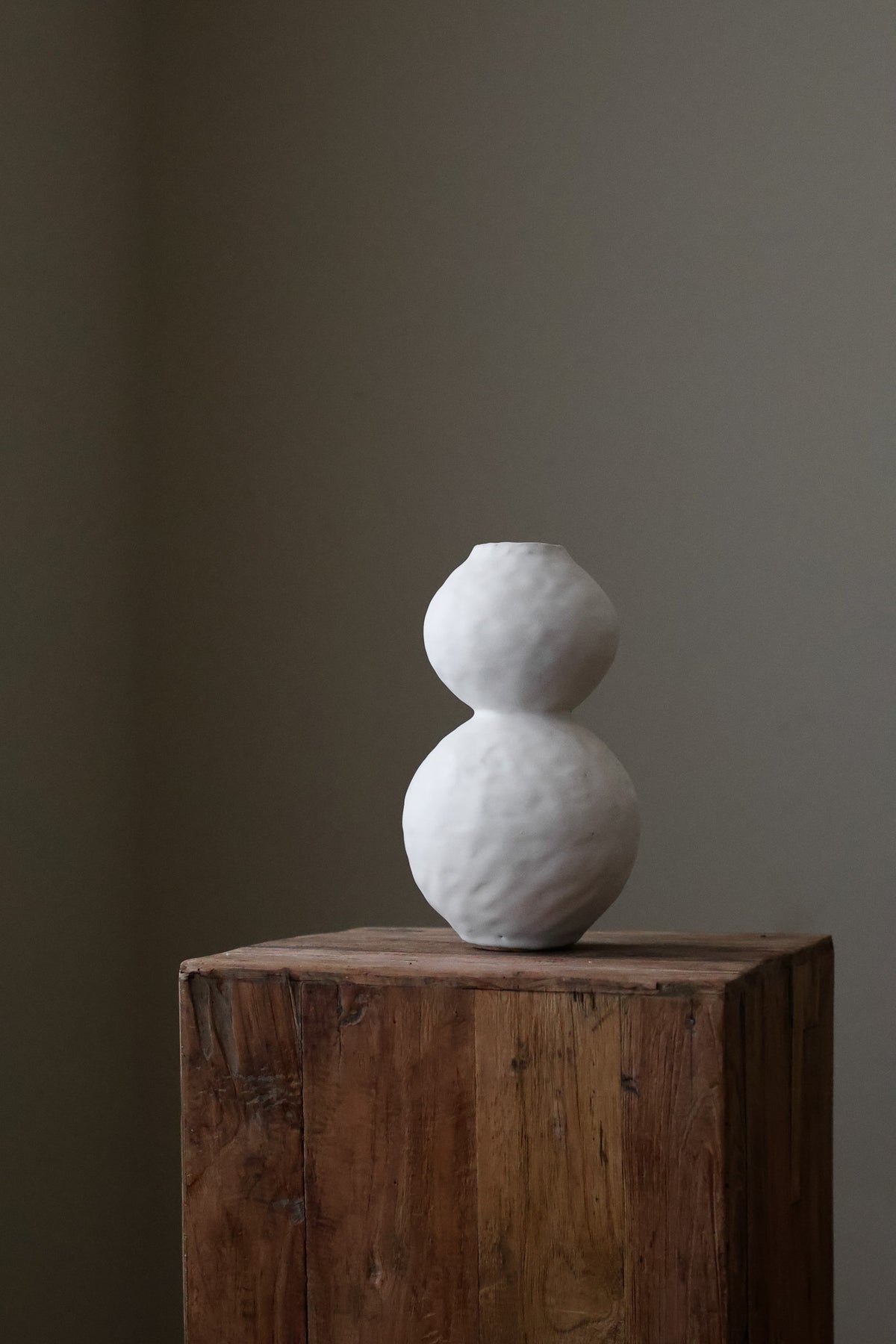 Hand-built white ceramic vase featuring two conjoined spherical shapes with a textured, matte finish.