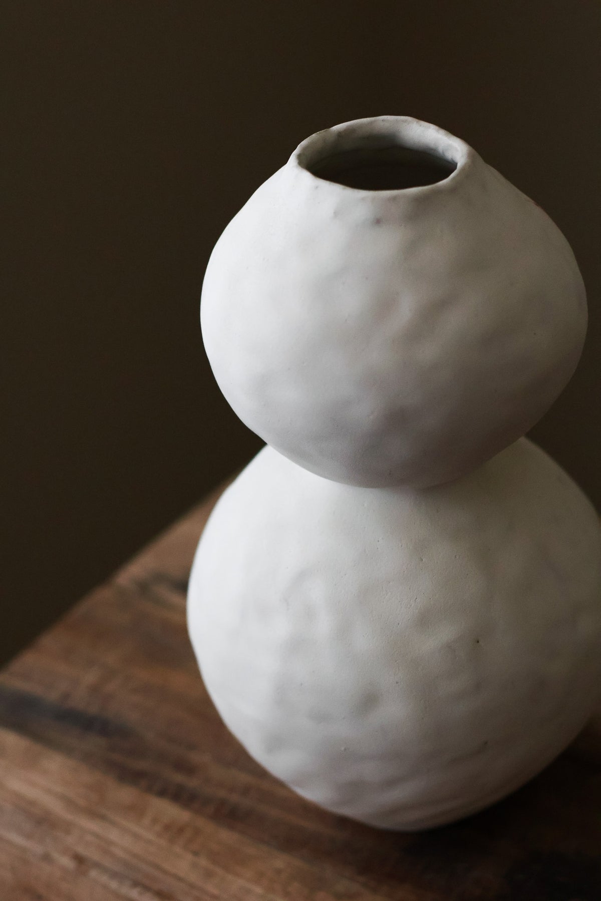 Hand-built white ceramic vase featuring two conjoined spherical shapes with a textured, matte finish.
