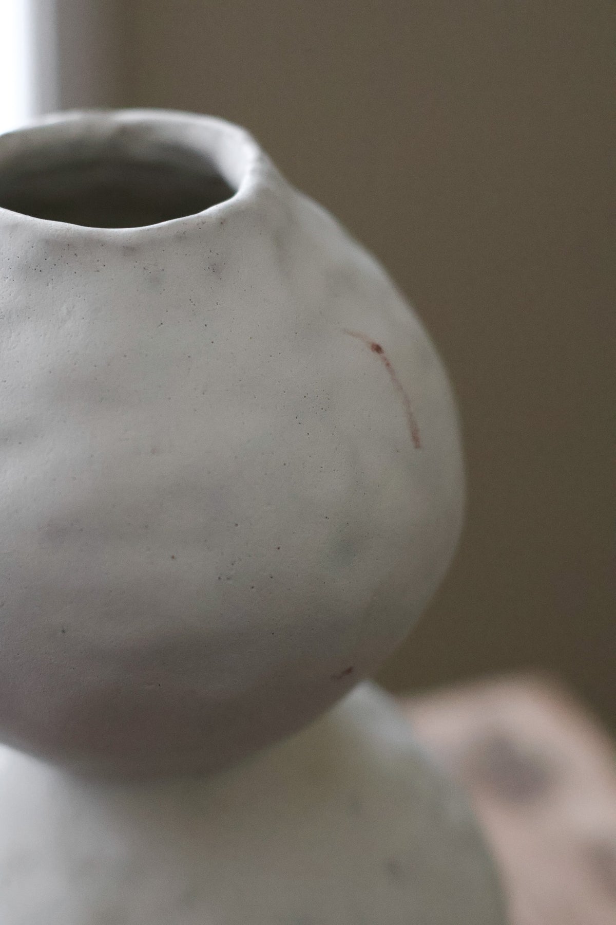 Hand-built white ceramic vase featuring two conjoined spherical shapes with a textured, matte finish.