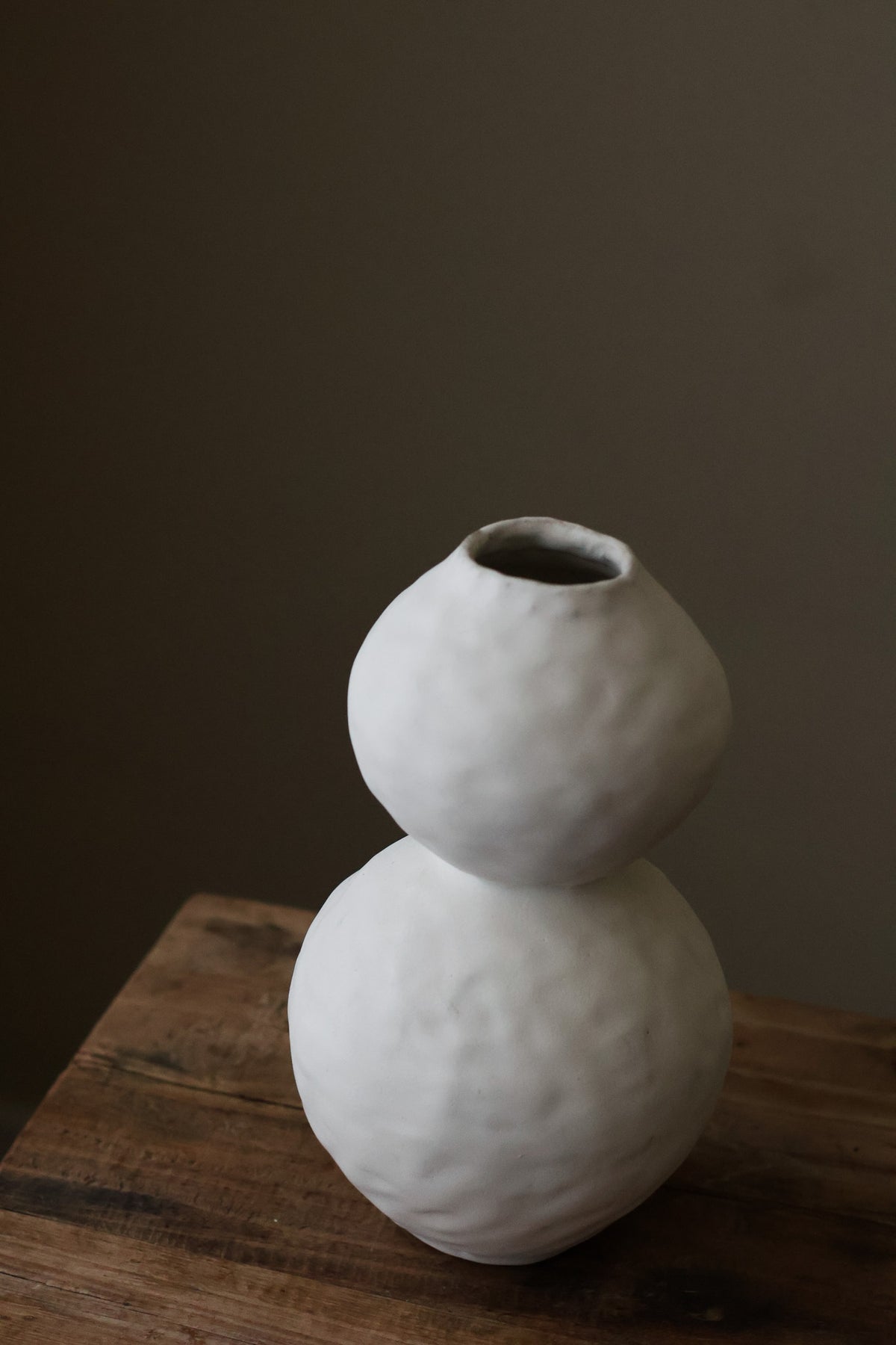 Hand-built white ceramic vase featuring two conjoined spherical shapes with a textured, matte finish.