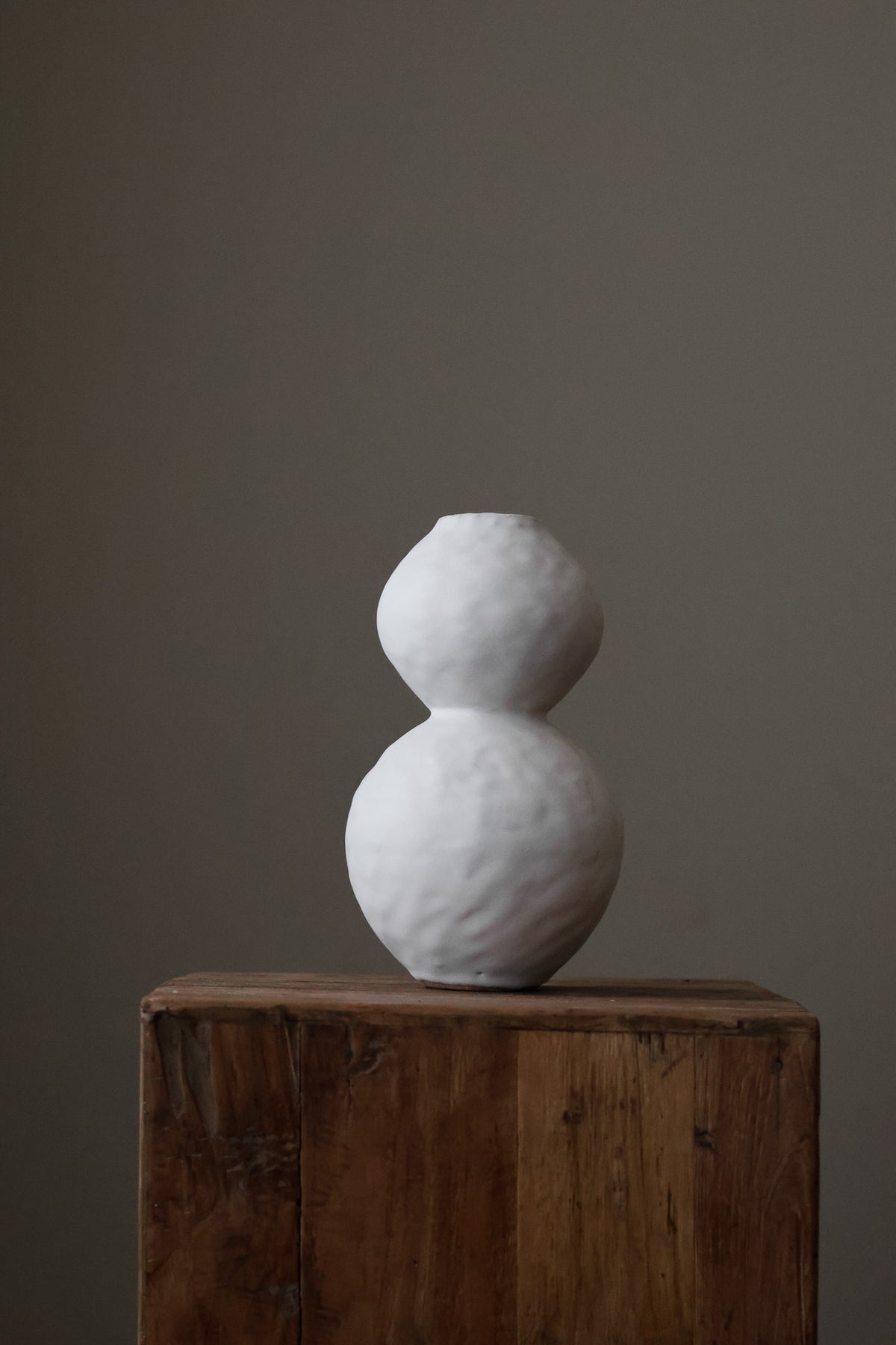 Hand-built white ceramic vase featuring two conjoined spherical shapes with a textured, matte finish.