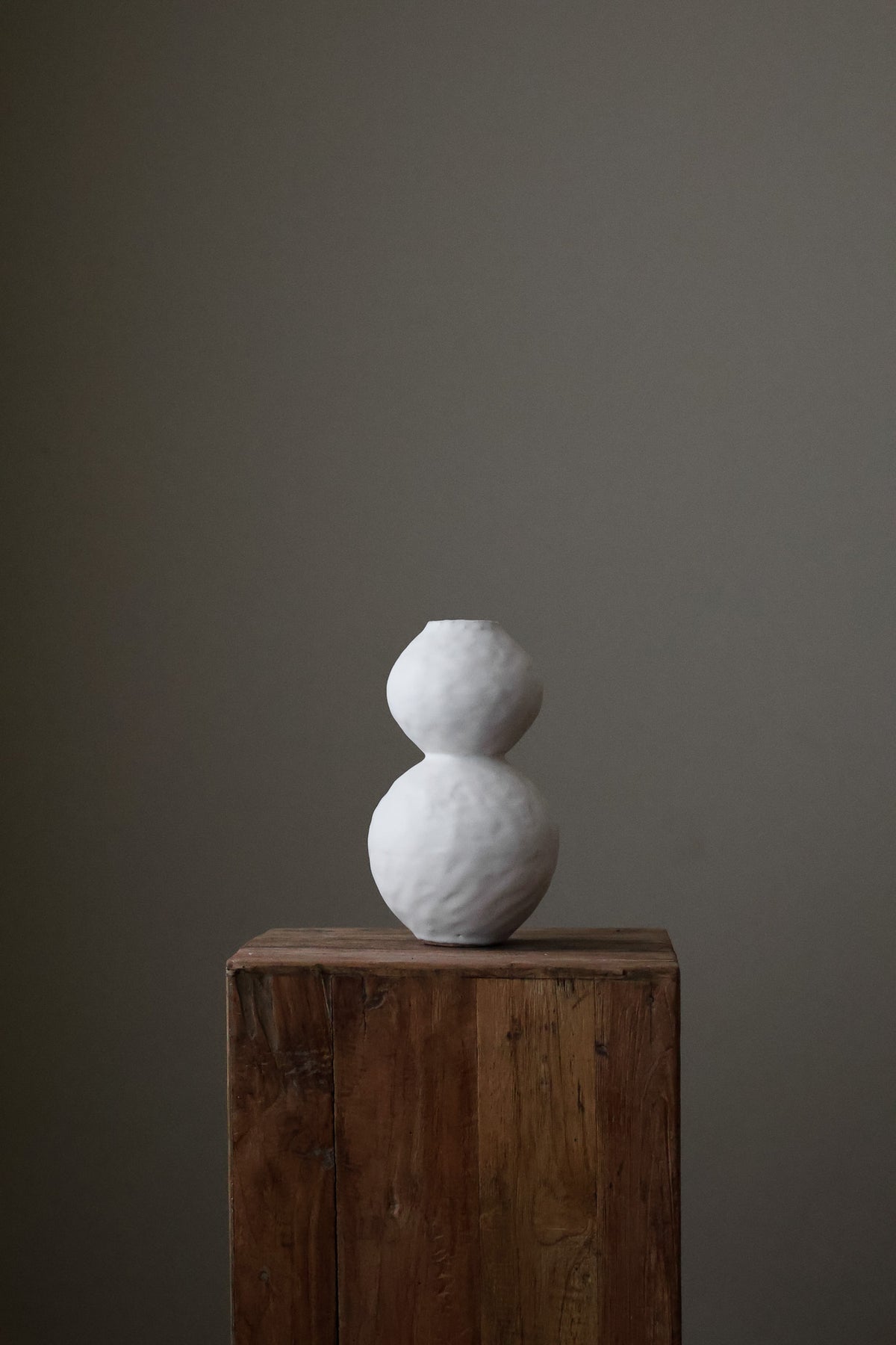 Hand-built white ceramic vase featuring two conjoined spherical shapes with a textured, matte finish.