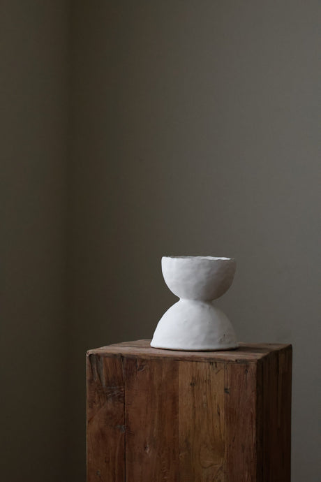 Modern sculptural vase featuring two opposing half-spheres joined seamlessly, creating a captivating design.