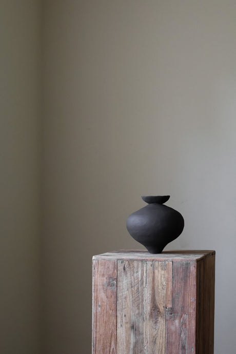 Unique sculptural vase with dish element by artist Hana, showcasing organic form and hand-built texture.