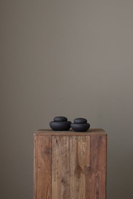 Crafted with a textured dark surface inspired by natural stone formations, Stone Jars are ideal for storing small items or serving as a striking statement piece.