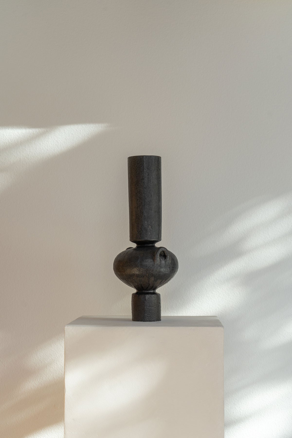 Handmade ceramic Isolated N.23 Ink vessel, black glaze and textured surface, inspired by Mediterranean artifacts.
