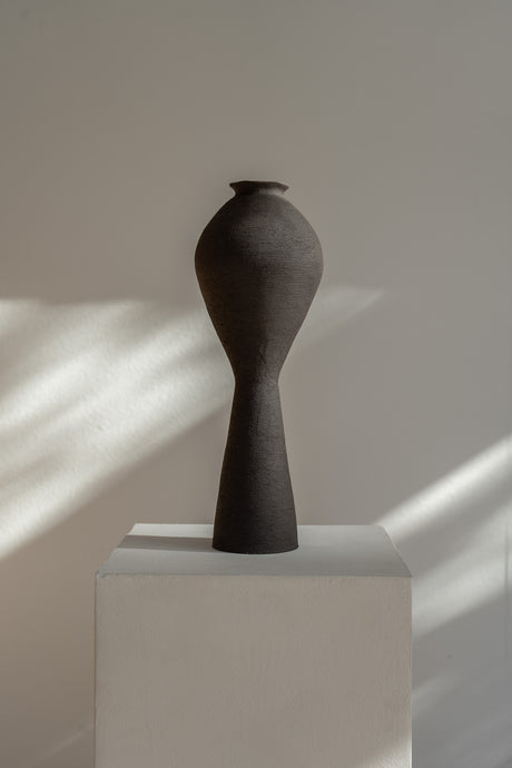 Large Ovular Vase by Ruby Bell Ceramics, hand-built with a raw textured black exterior and clear glazed interior, embodying the grace of the female form. This unique sculptural piece showcases the tactile beauty of clay, perfect for a statement accent or floral display.
