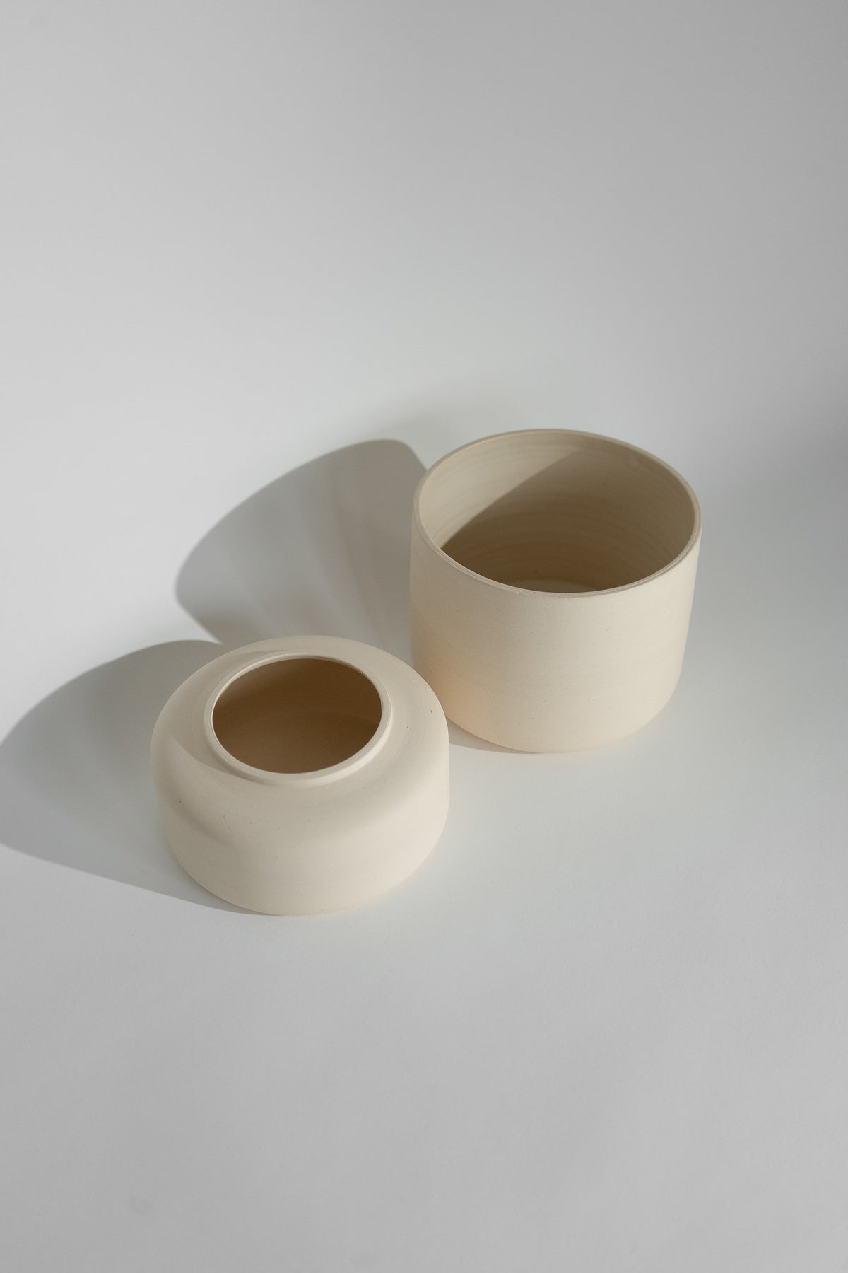Crafted in cream with a sleek two-piece design, this stylish planter elevates any space. Featuring a removable top for easy water disposal or self-watering, it enhances your home décor while showcasing nature's beauty.