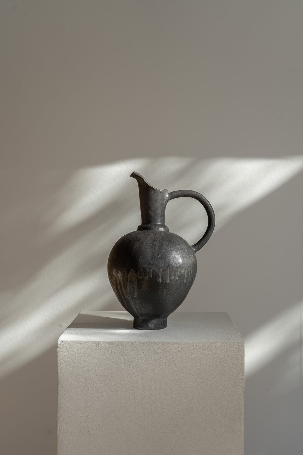 Handmade Oinochoe Pitcher INK by Canoa Lab, featuring a matte black glaze and textured stoneware. Inspired by ancient Mediterranean design, this decorative vase adds timeless elegance to any space.
