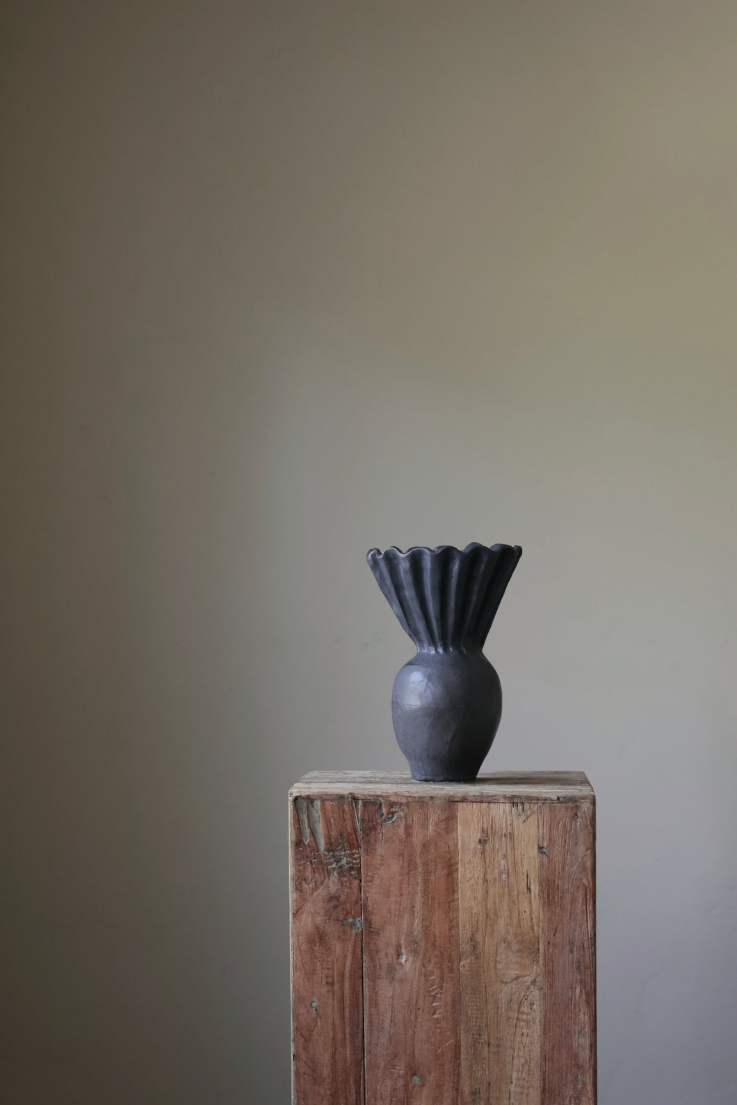 Ink sculptural vase with a hand-formed, ruffled rim and textured surface. 