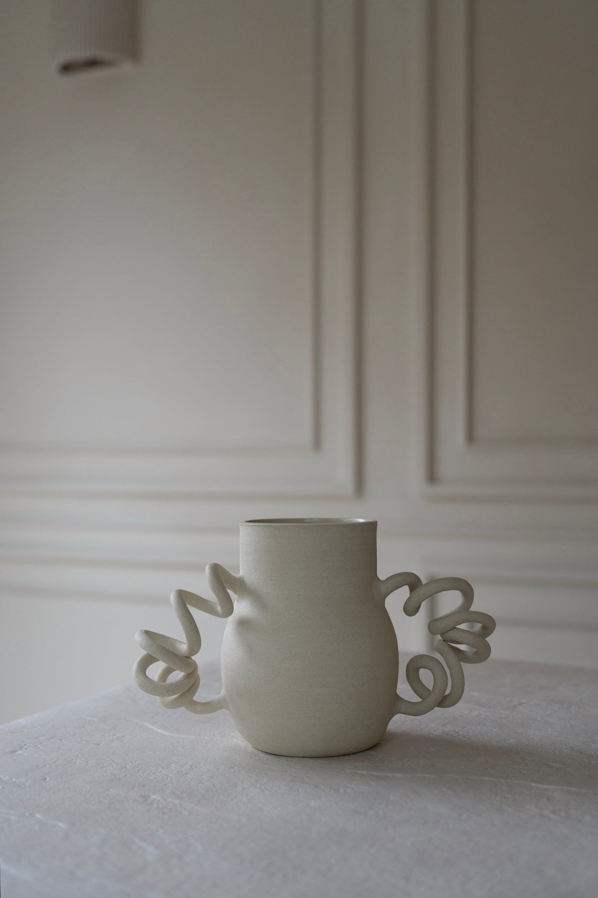 Boinggg Vase II by Kuu Pottery, featuring a whimsical design with spring-inspired handles.